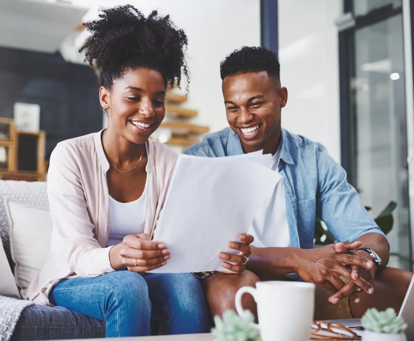Couple on couch doing paperwork