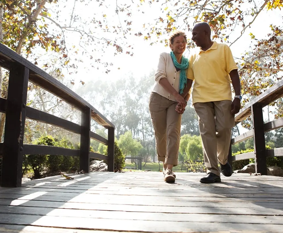 happy couple holding hands while enjoying a walk in nature