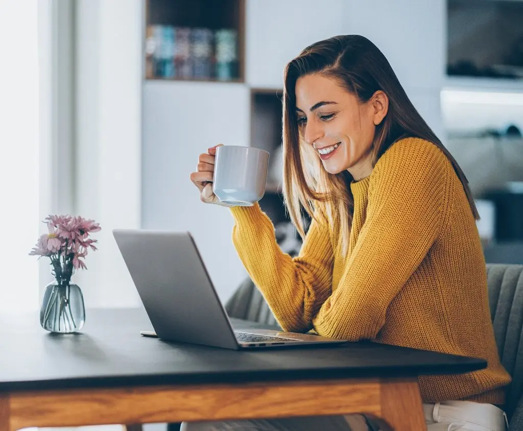woman sitting at a desk in a home office space