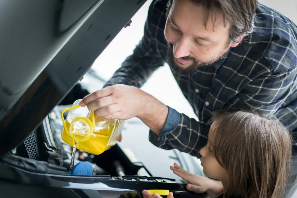 A man taking care of his car engine