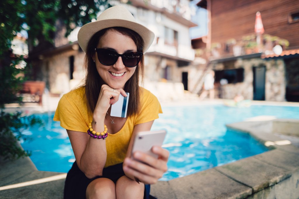 A picture of a girl smiling by the pool