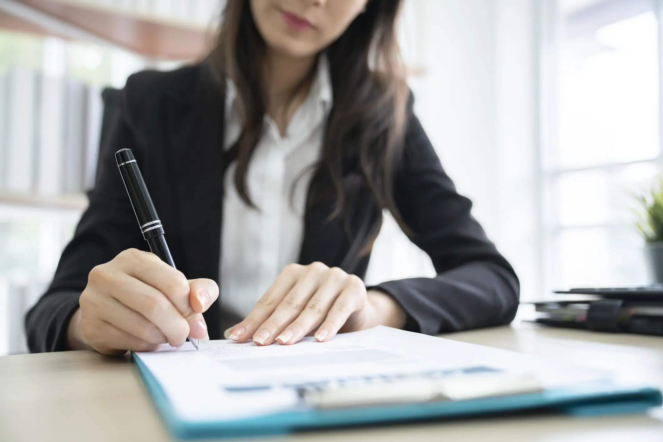Woman signing loan documents
