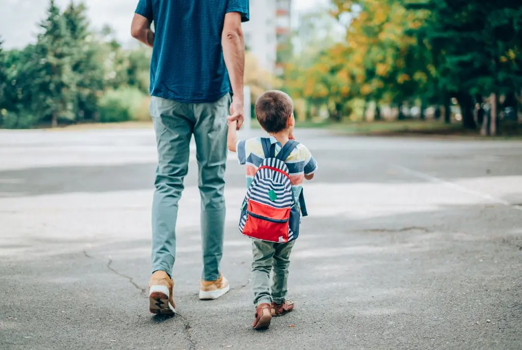 Father walking son to elementary school