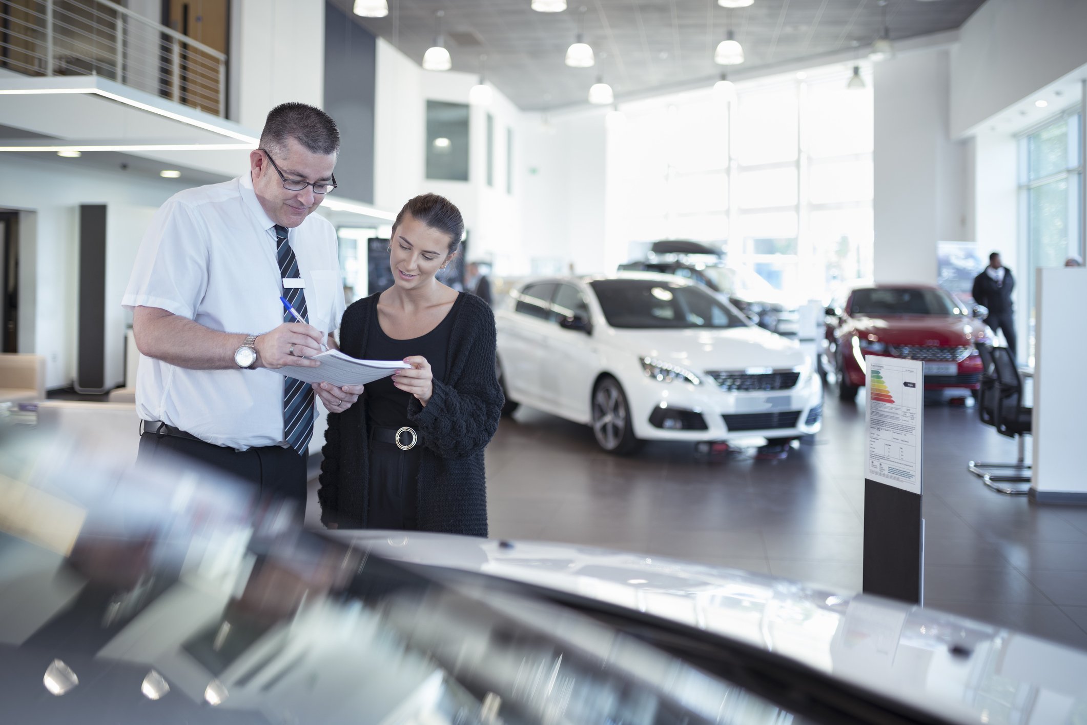 People negotiating a deal at a car dealership