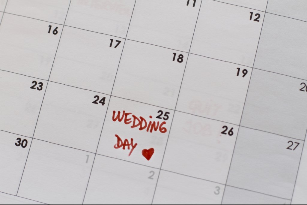 Saving a date for a dream wedding by putting it on a calendar 