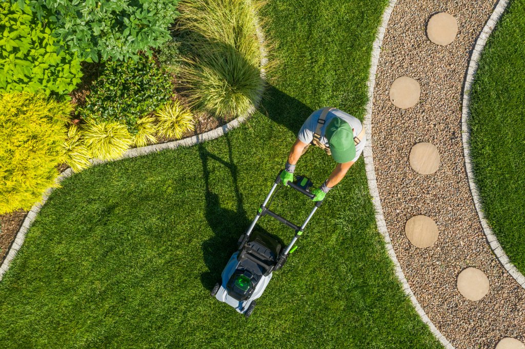 Aerial shot of man mowing the lawn