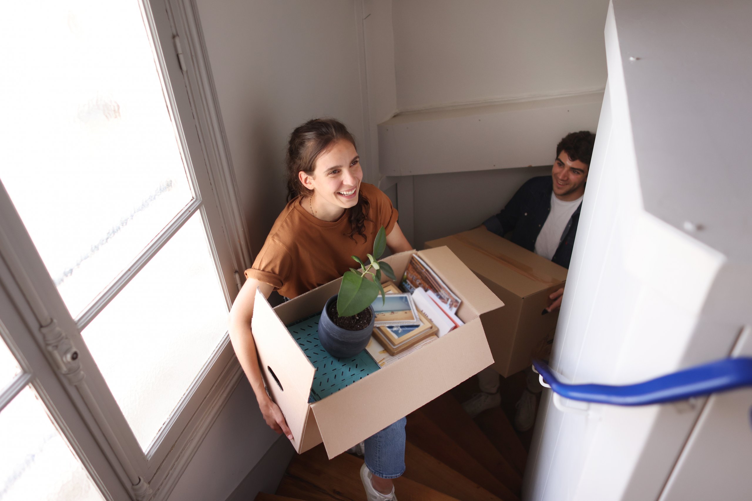 young women and man moving into an apartment