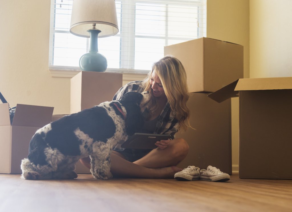 woman with dog moving into a new apartment 