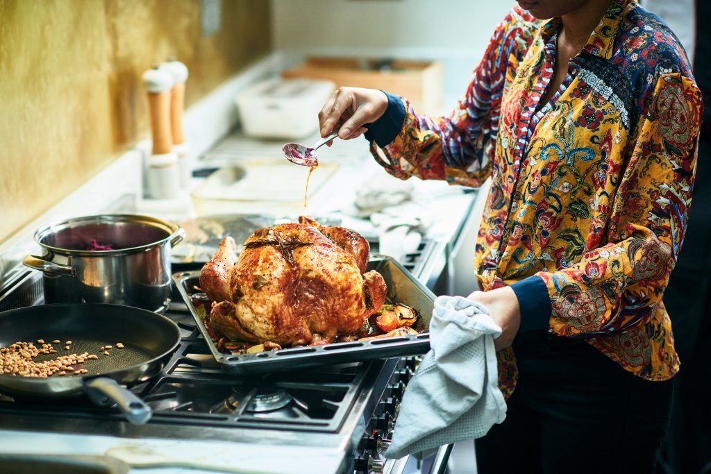 Woman basting turkey