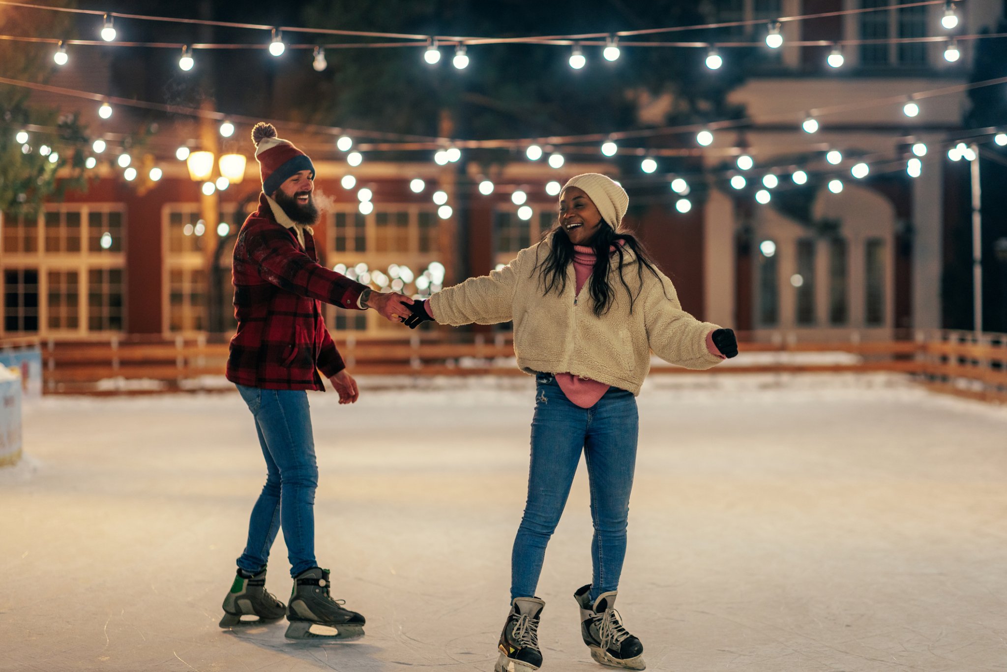 Couple Ice skating and holding hands