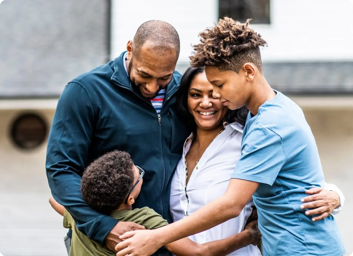 Family of four hugging
