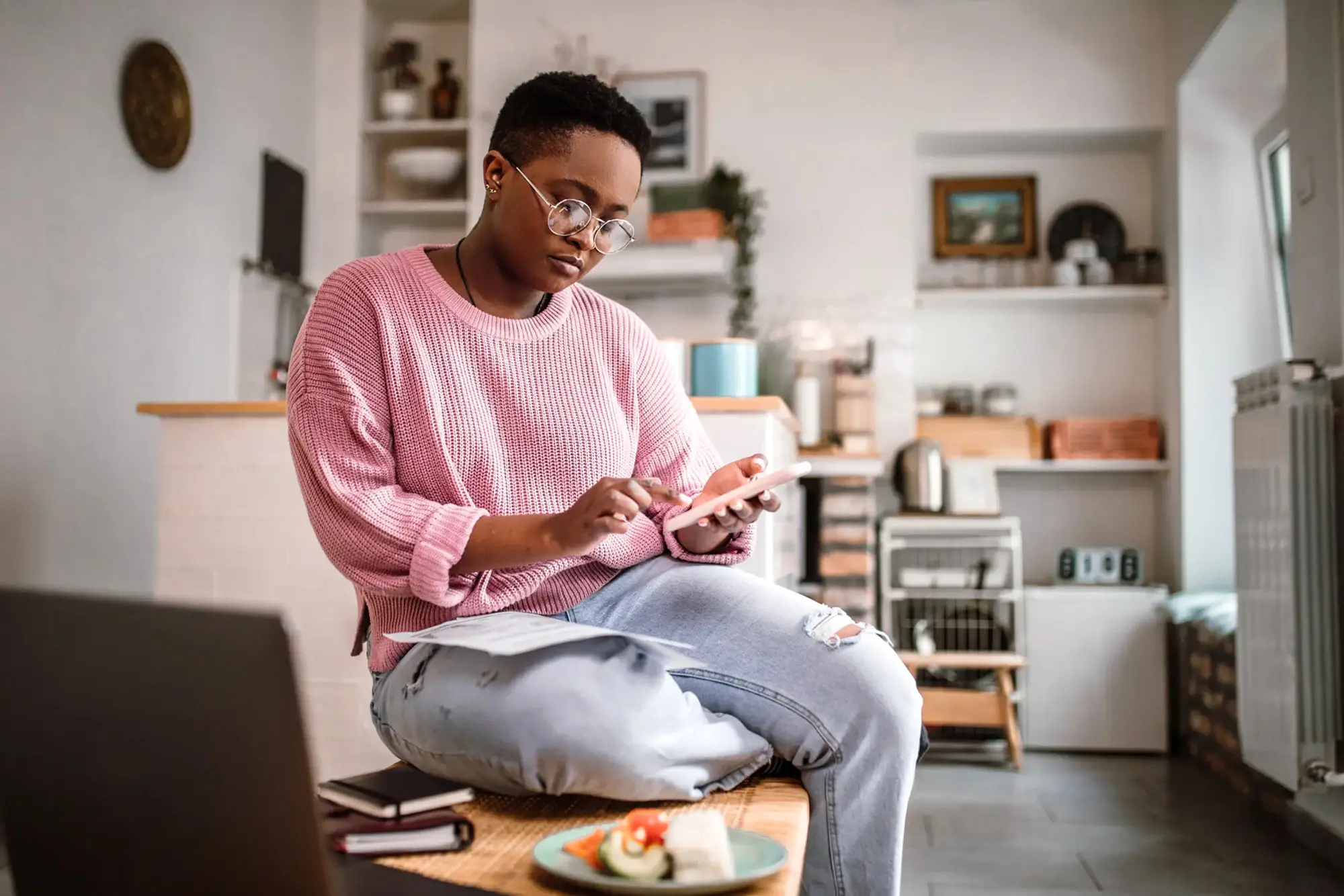 Young Woman does calculations on her phone