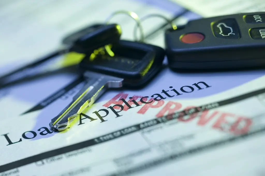 Application for an auto loan with car keys on top of it