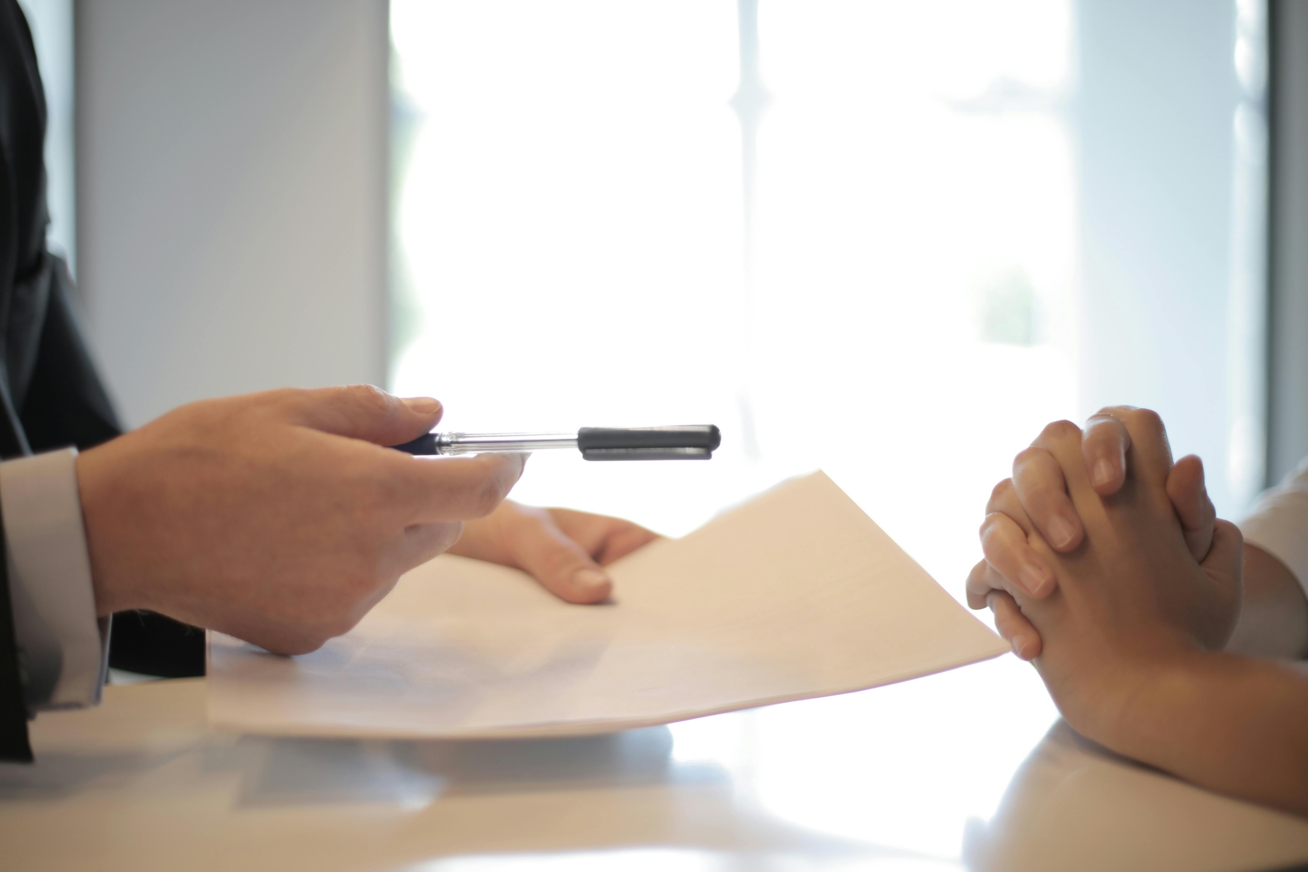 Two people reviewing and signing loan documents.