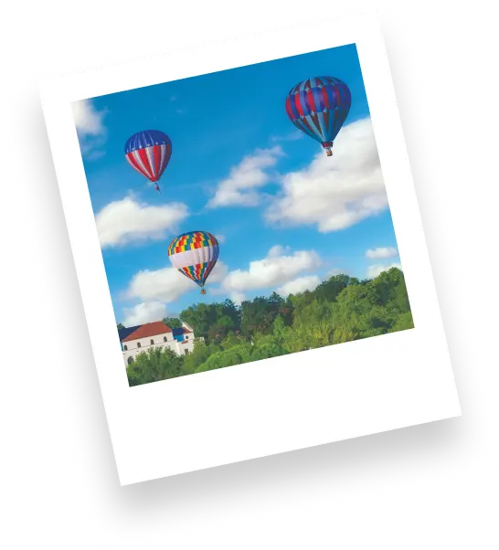 Polaroid photo of hot ait balloons in the sky