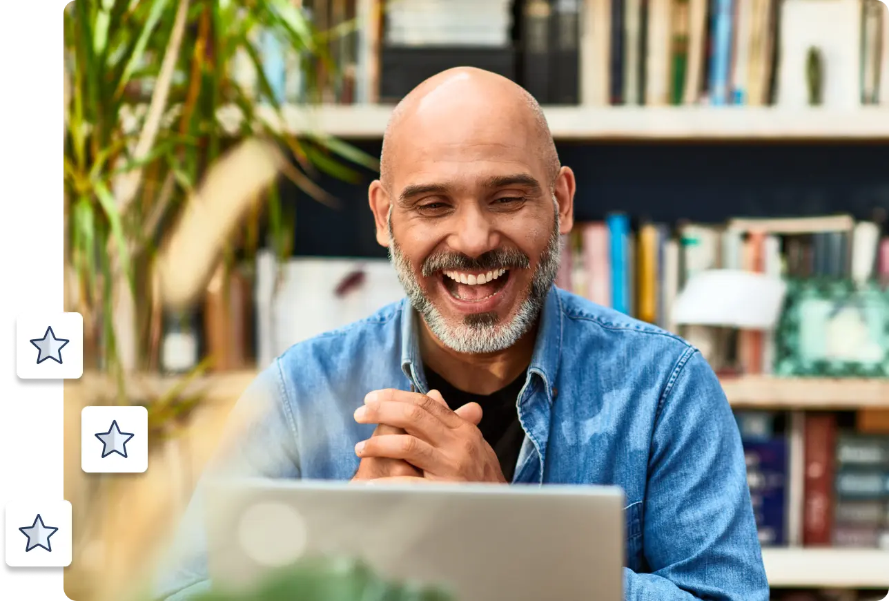 Man happy and clapping while looking at laptop