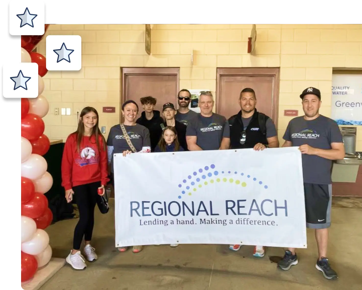 Regional Reach members holding sign with their logo
