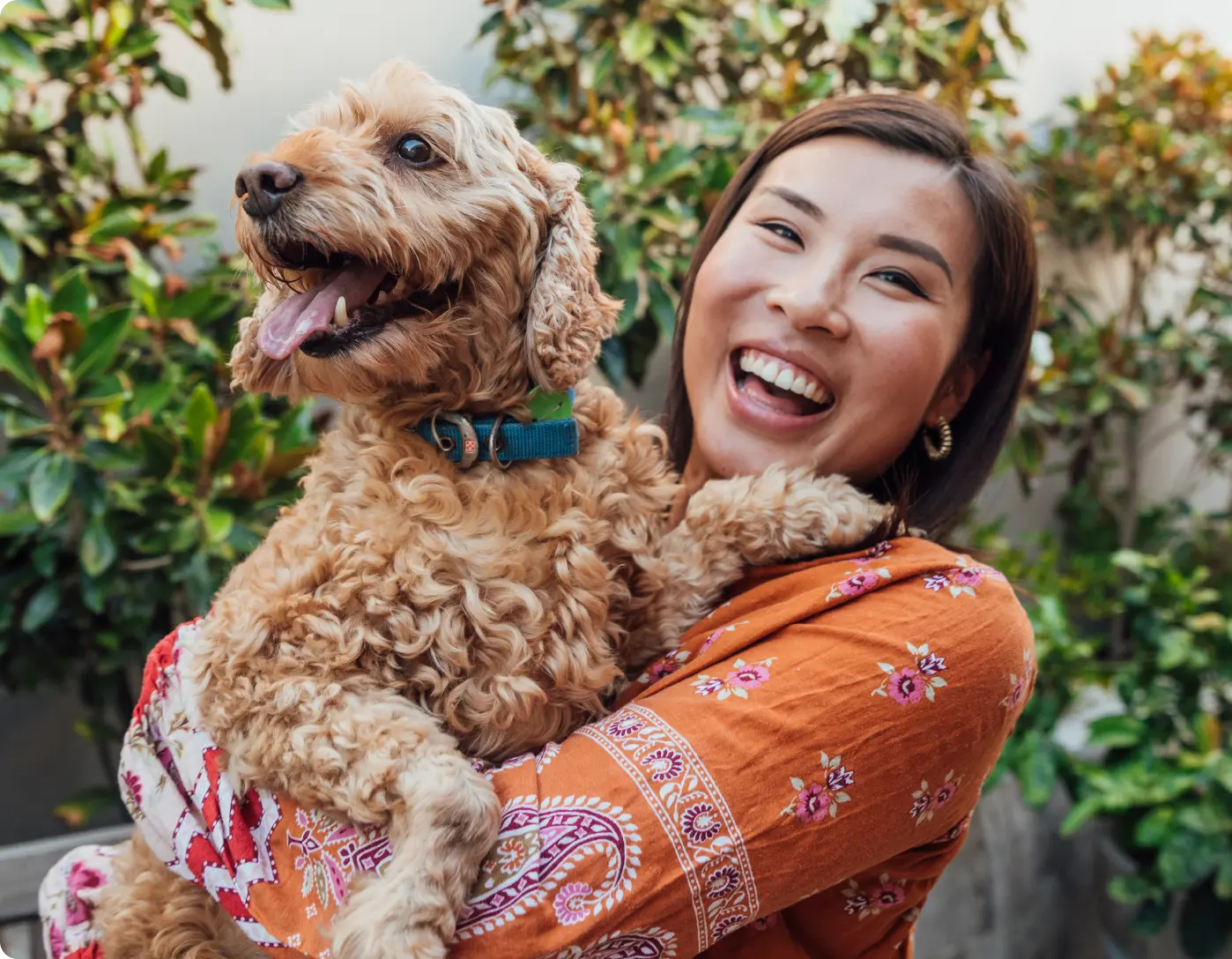 Woman smiling at camera holding a dog